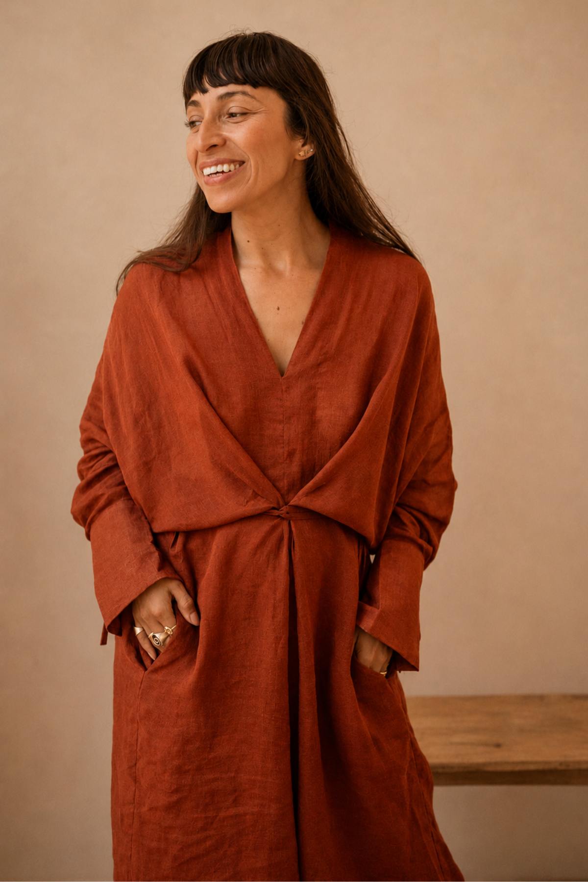 Front view of a woman wearing the Tara Set by Myrah Penaloza, a semi-sheer ramie linen tunic over 100% linen Mona pants in Harvest Moon Red, handcrafted in Bali
