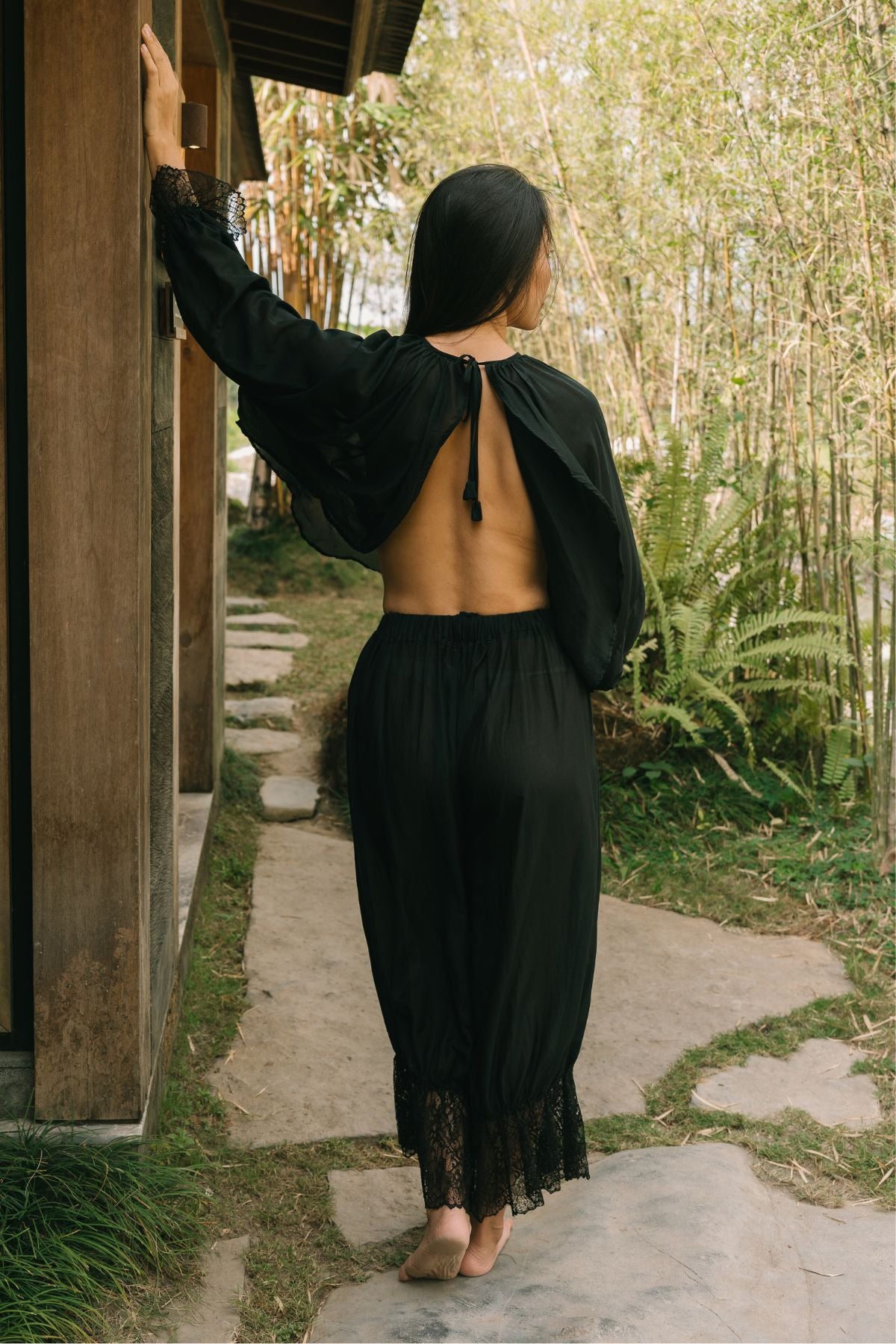 Back view of the Anusara Evening Set by Myrah Penaloza, the top open at the back with a single tie at the neck, lace at the pant hem.