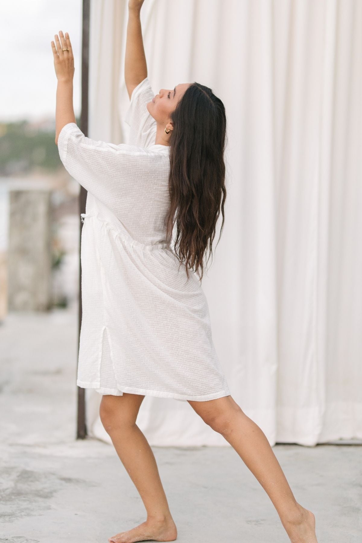 Full-length view of the Bona Dress Short Cotton by Myrah Penaloza in cotton, handcrafted in Bali by artisan families.