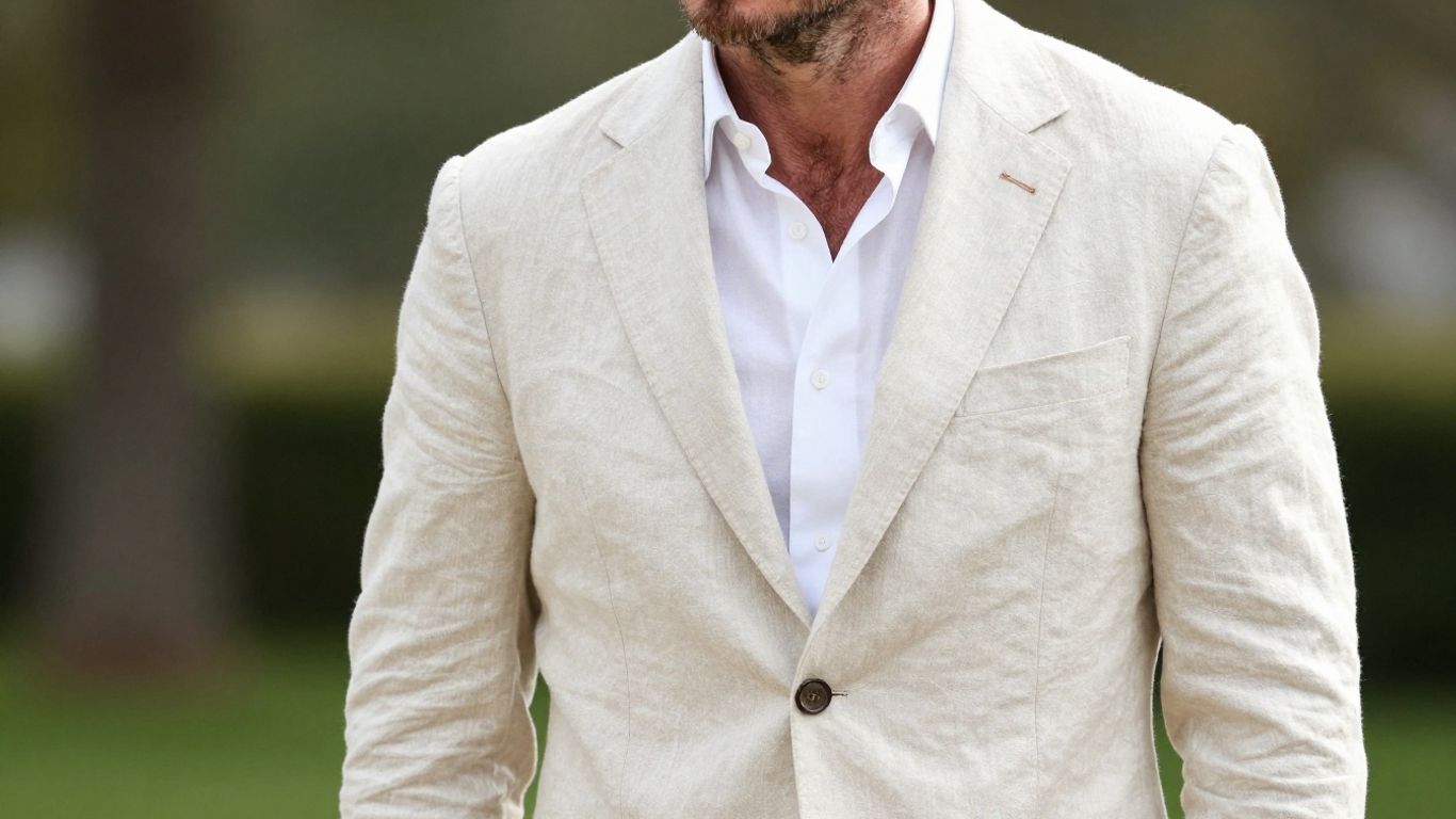 [David Beckham] in a stylish linen suit.