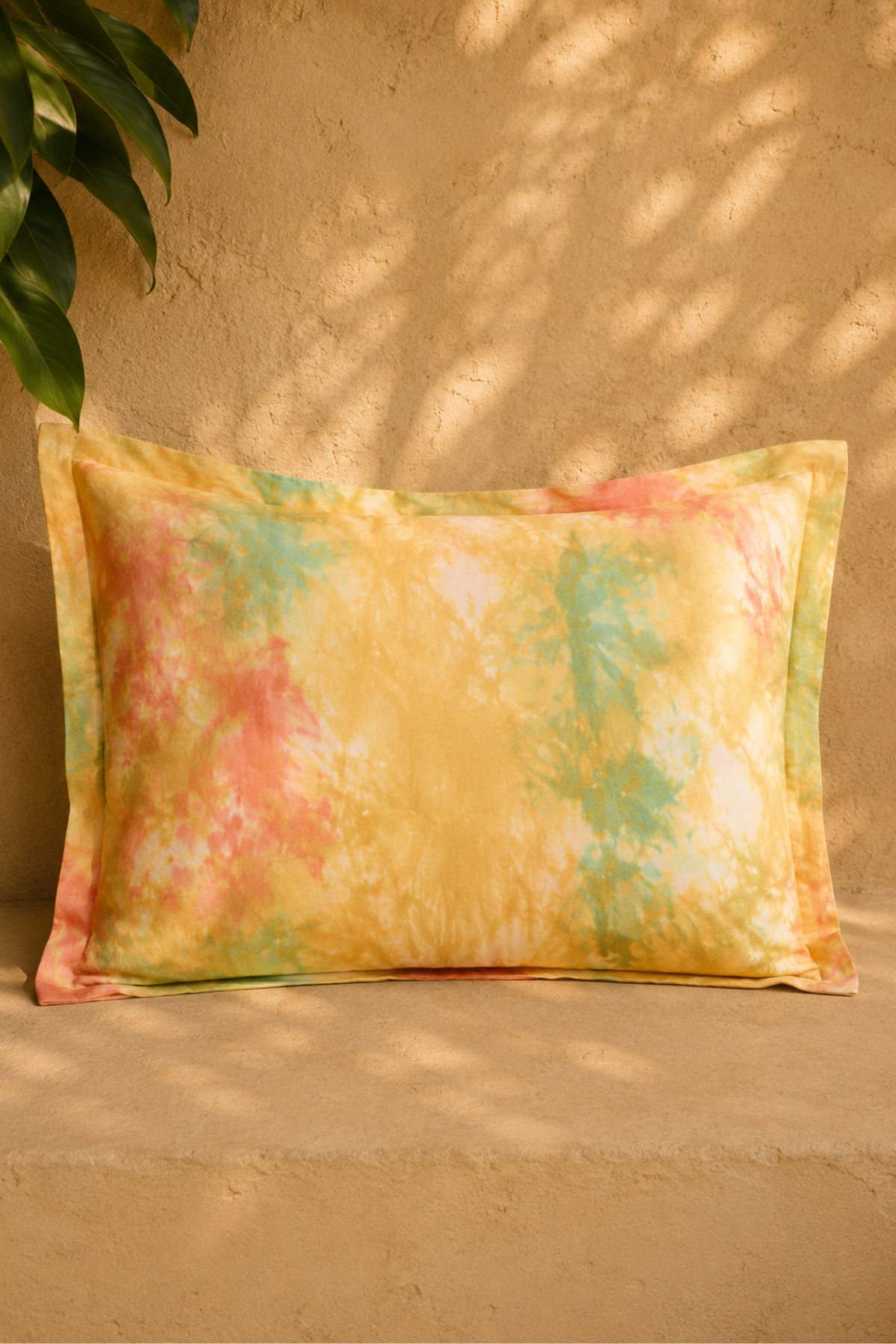The Bali Linen Pillowcase in Golden Sunset on a bed, 100% French linen botanical-dyed and stonewashed in Bali by Myrah Penaloza