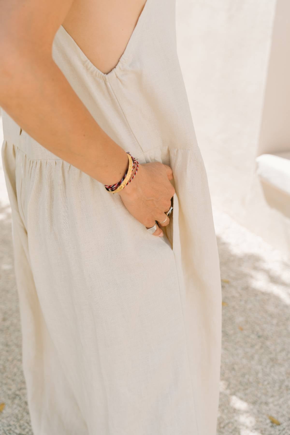 Side detail of the Monaya Playsuit by Myrah Penaloza in Moonlight stone washed linen, showing the gathered waist seam and hand pocket. Handcrafted in Bali.