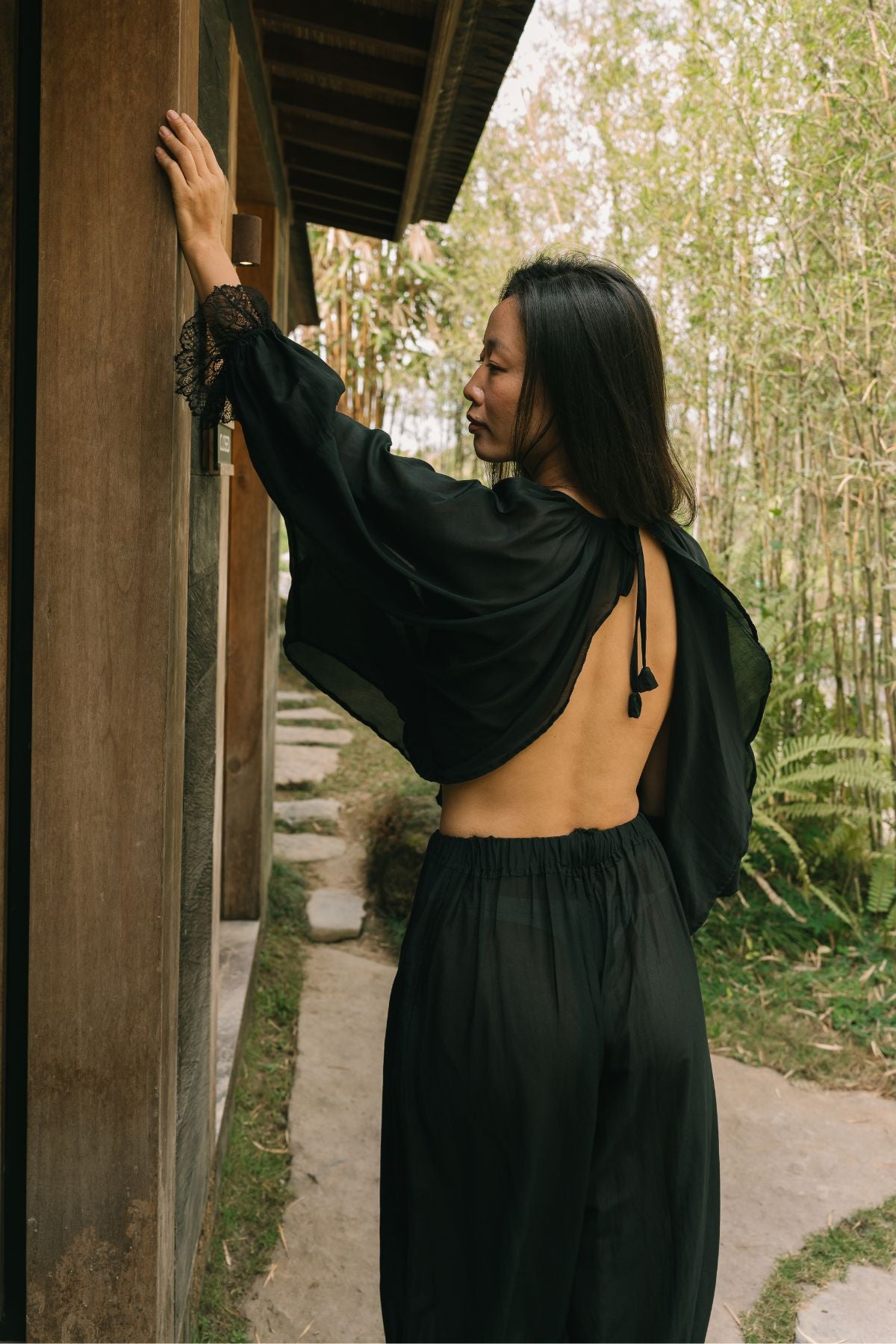 Open back of the Anusara Evening Set top in Dark Moon Black, tied at the neck, with hand woven lace at the cuff.
