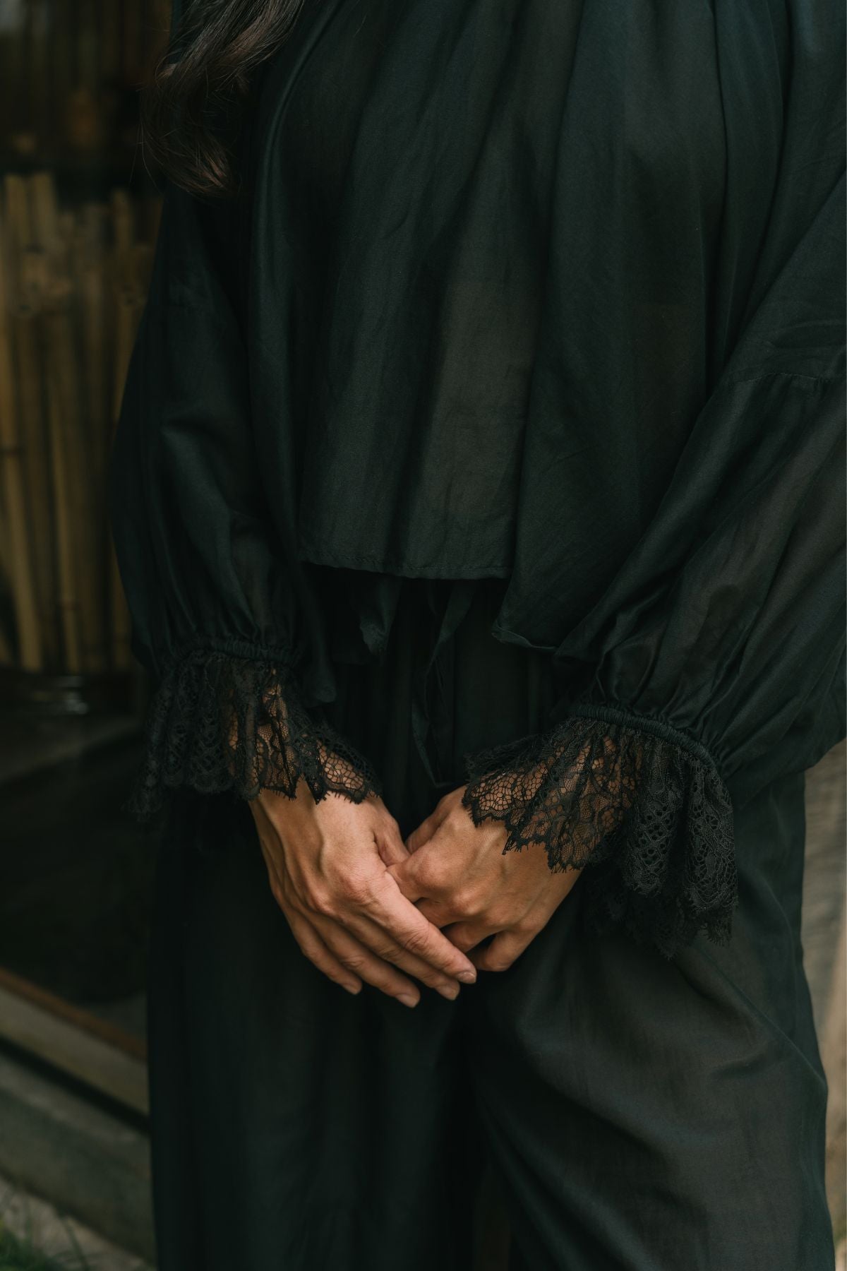 Close detail of the hand woven lace at the cuffs of the Anusara Evening Set top in Dark Moon Black silk and cotton.