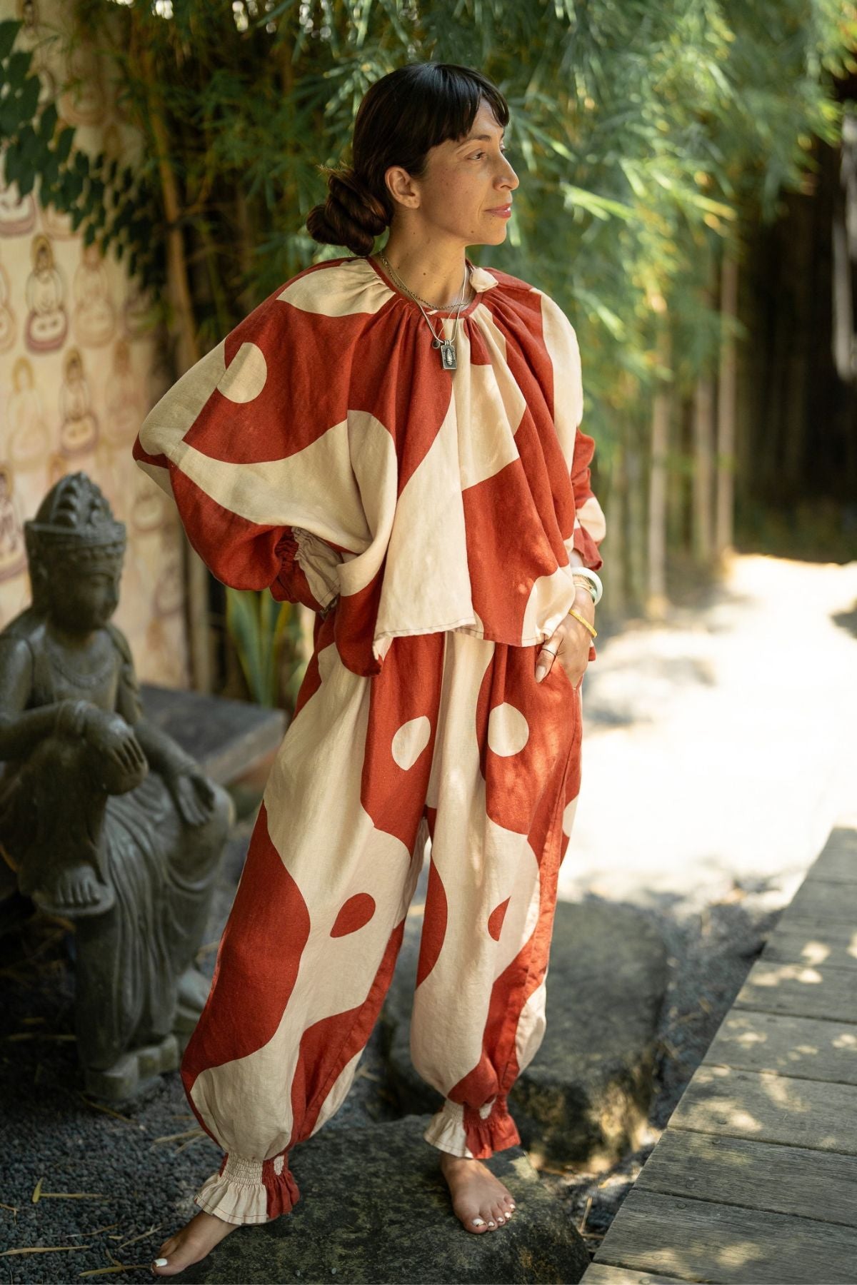 Woman wearing the Two Moons Anusara Set, red and moon milk linen moving together