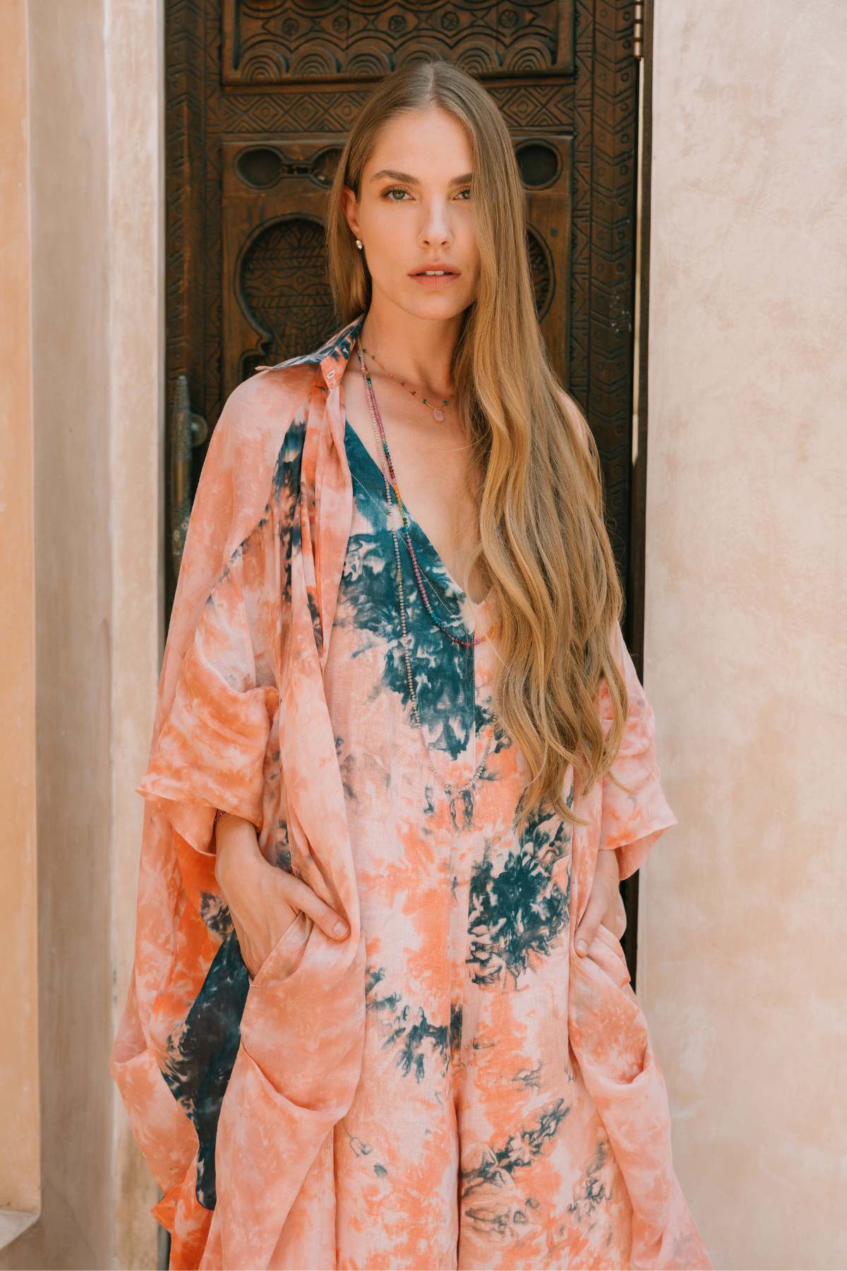 Ramie Origami Gown Set outdoor lifestyle by Myrah Penaloza. Uluwatu Sunset botanical dye, ceremonial slow fashion, handmade Bali.