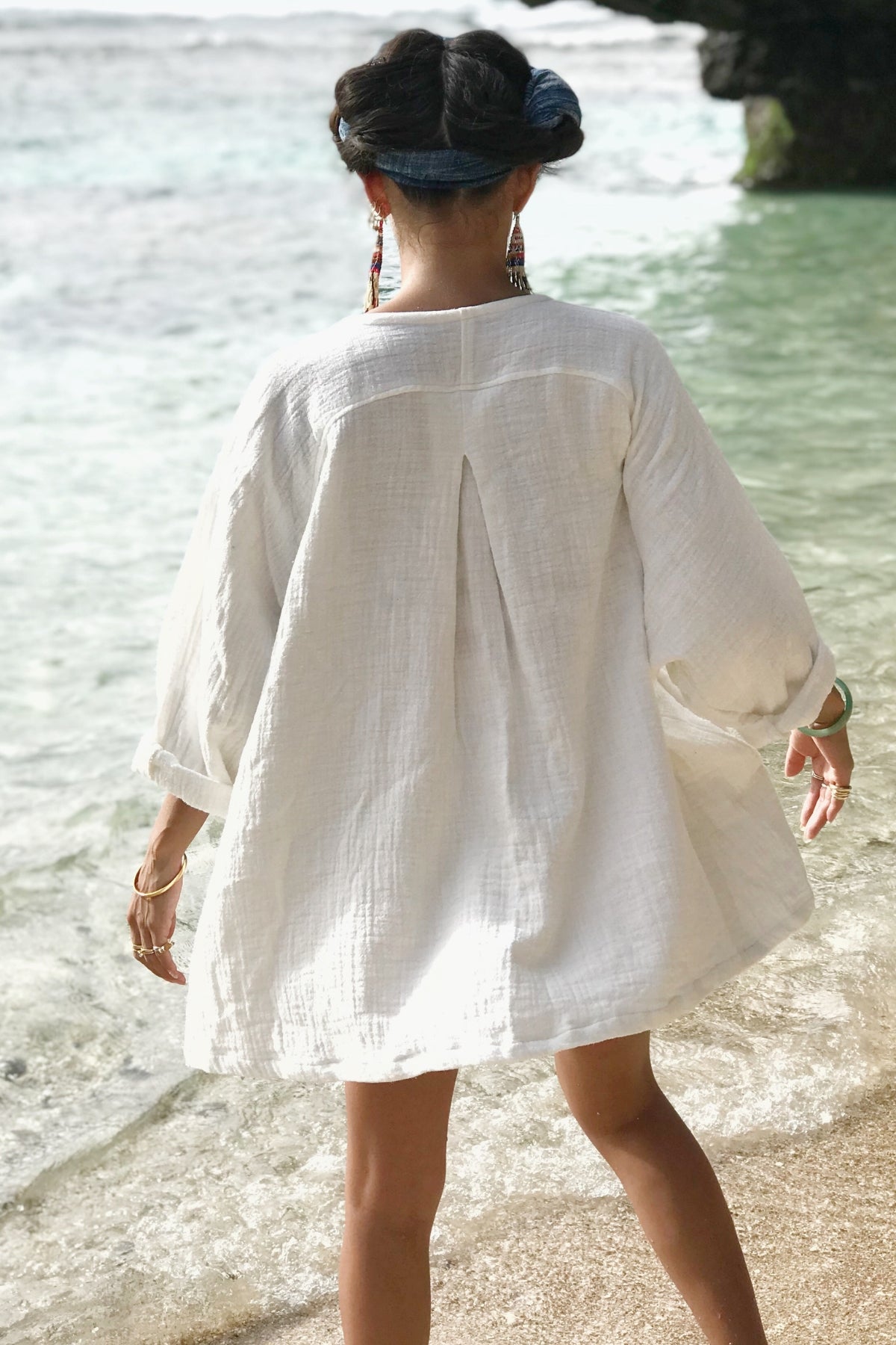 Seated view of the White Golden Chain Jacket by Myrah Penaloza, handcrafted in Bali by artisan families.