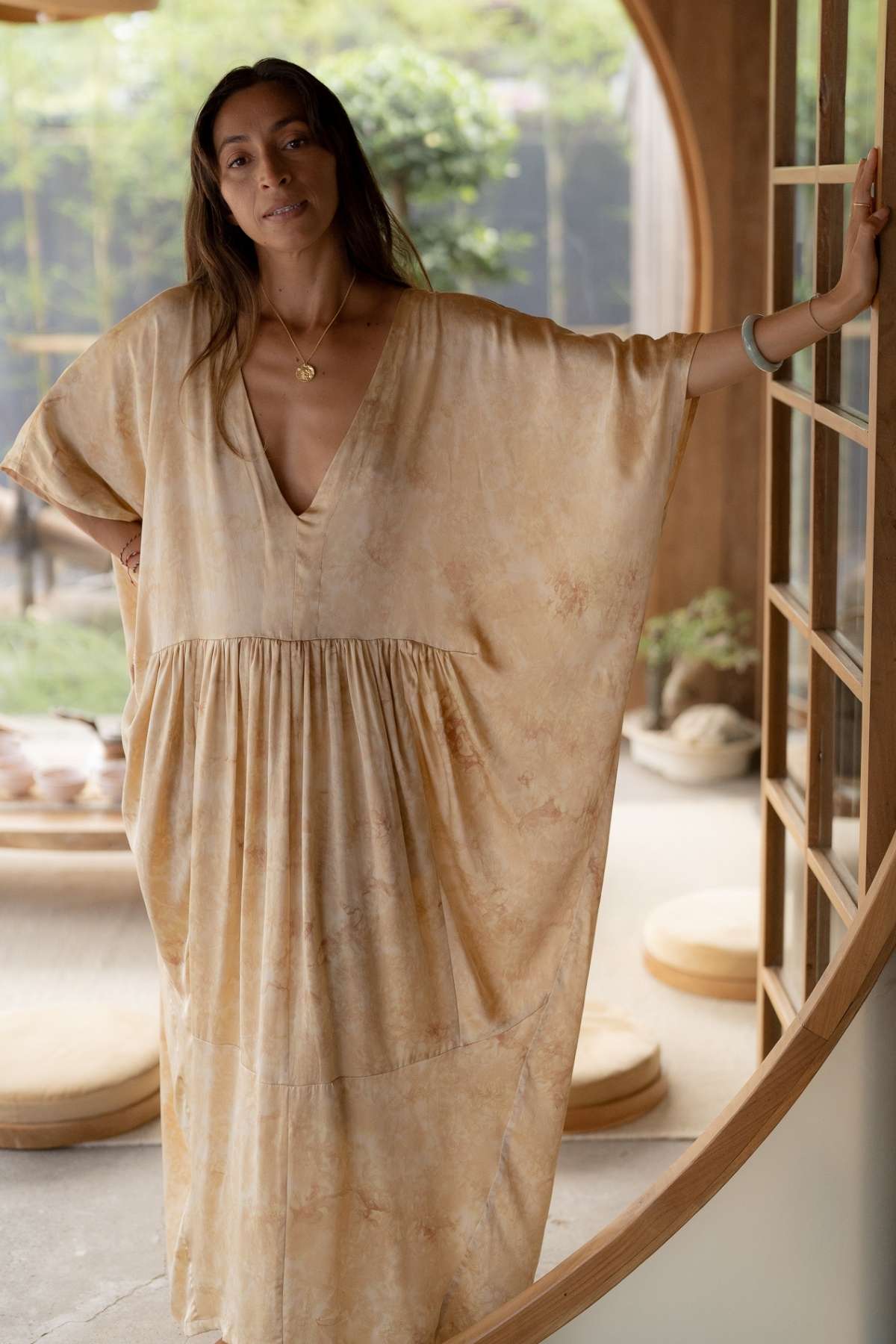 Luxury silk gown hand-dyed with roses by Balinese artisan families, conscious slow fashion