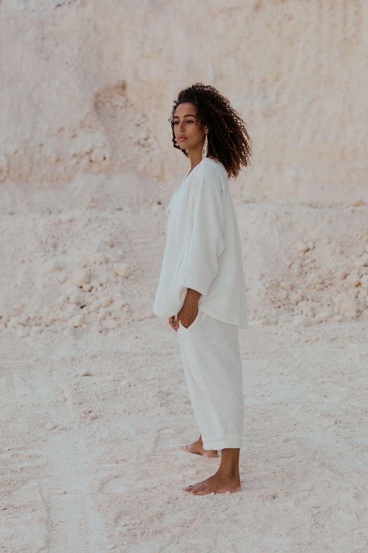 Woman in movement wearing the White Golden Chain Jacket by Myrah Penaloza, handcrafted in Bali by artisan families.